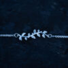 Close up of a silver leaf bracelet with delicate leaf details