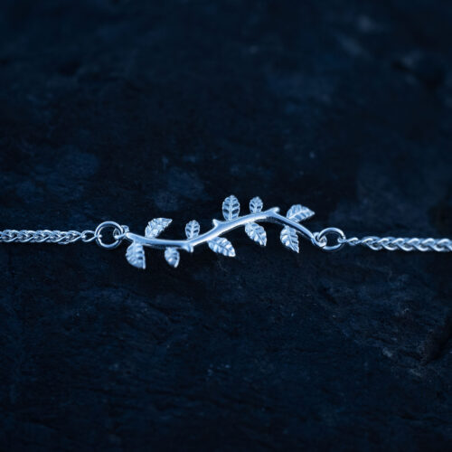 Close up of a silver leaf bracelet with delicate leaf details