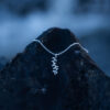 A silver leaf pendant necklace with delicate botanical details
