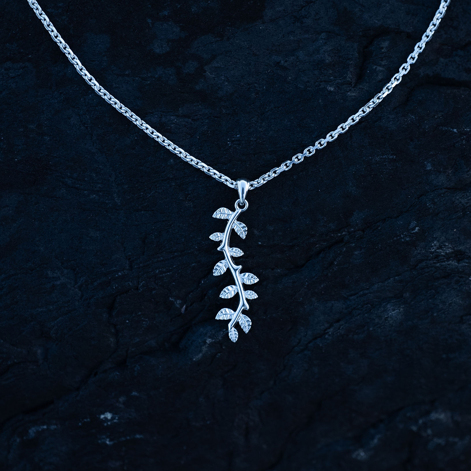 A silver leaf pendant necklace with delicate botanical details